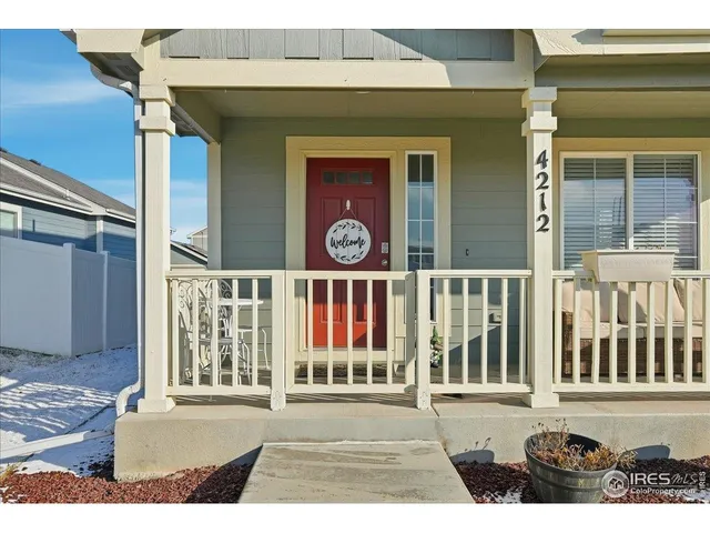 a view of a brick house with large windows