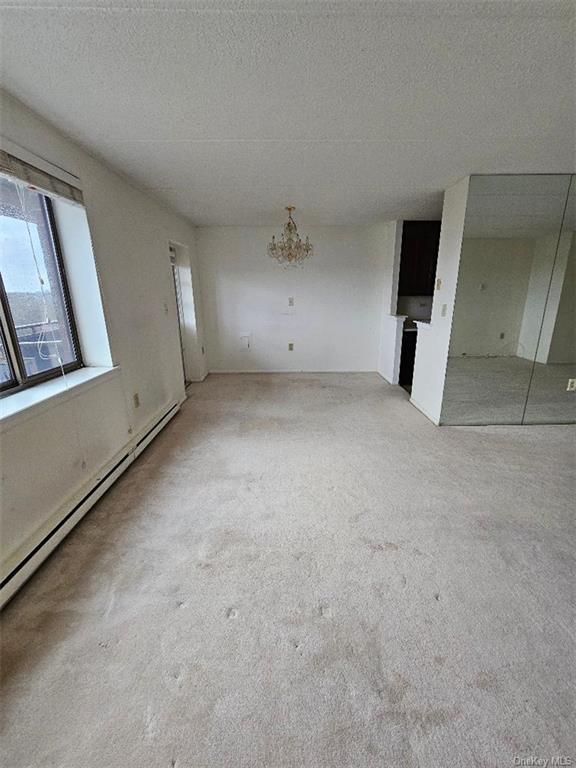 160 Academy Street, Unit 3N Poughkeepsie, NY 12601 - Photo 12 of 12 an empty room with a mirror and a ceiling fan