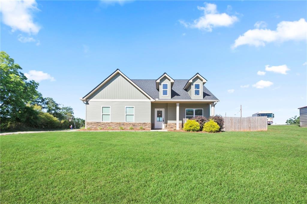 64 Neal Little Road Carnesville, GA 30521 - Photo 2 of 17 a view of a house with a big yard and large trees