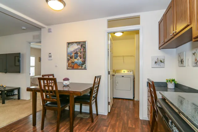 a view of a dining room with furniture and wooden floor