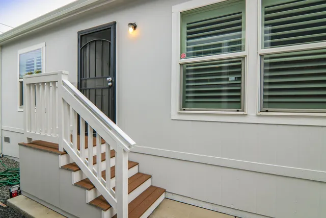 a view of staircase with white walls and a window