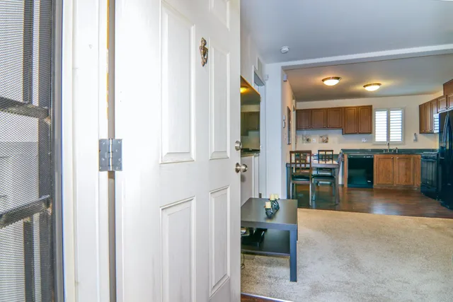 a open kitchen with stainless steel appliances a refrigerator and a sink