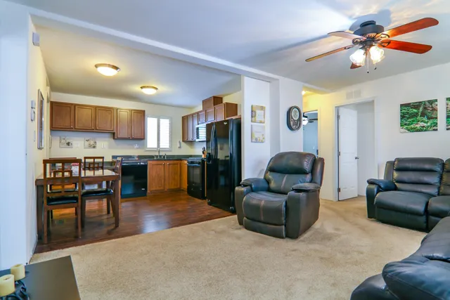 a living room with furniture and kitchen view