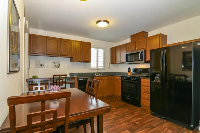 a kitchen with stainless steel appliances granite countertop a refrigerator stove microwave and sink