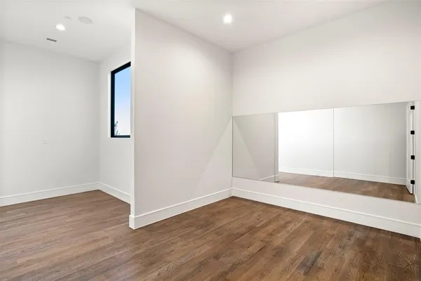 an empty room with wooden floor