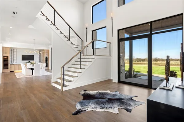 a view of entryway and hall with wooden floor
