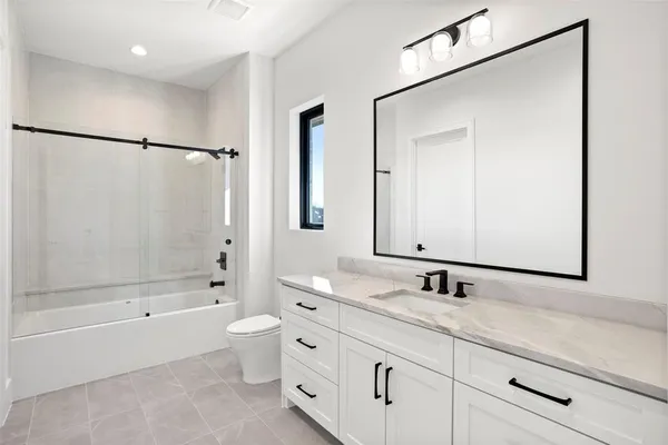 a bathroom with a double vanity sink mirror double shower and a bathtub