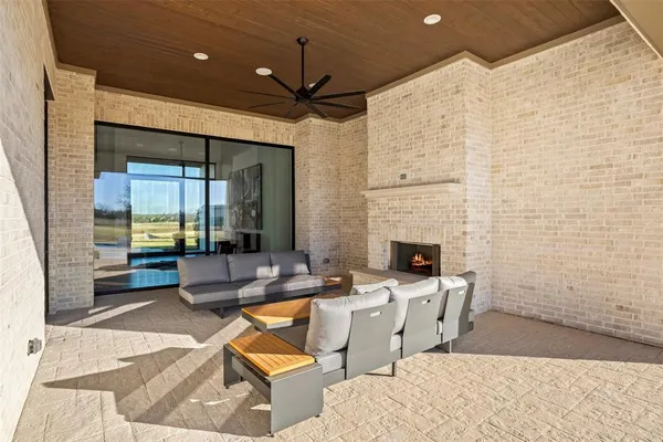 a outdoor space with patio the couches and a fireplace