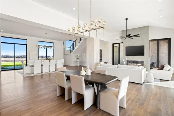 a view of a dining room with furniture a chandelier and wooden floor