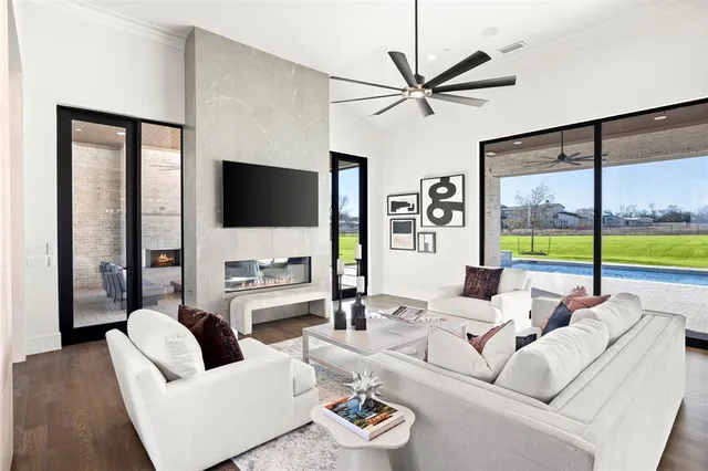 a living room with couches a coffee table and a flat screen tv