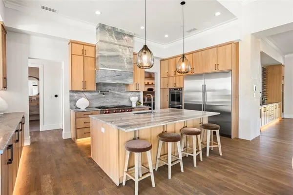 a kitchen with wooden floor and white appliances