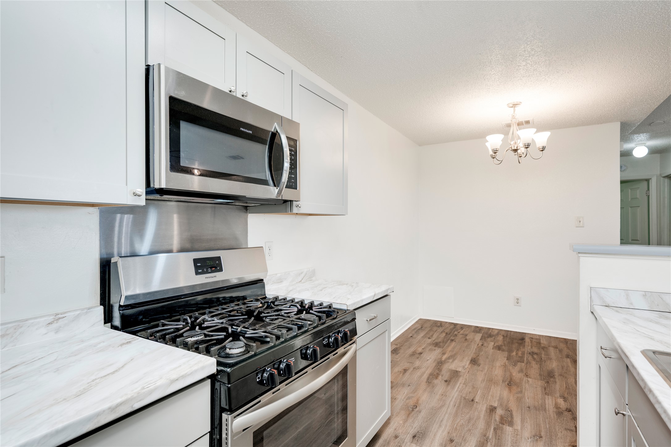 7918 West Gate Boulevard Austin, TX 78745 - Photo 23 of 31 Modern kitchen with stainless steel appliances and ample counter space for culinary endeavors.