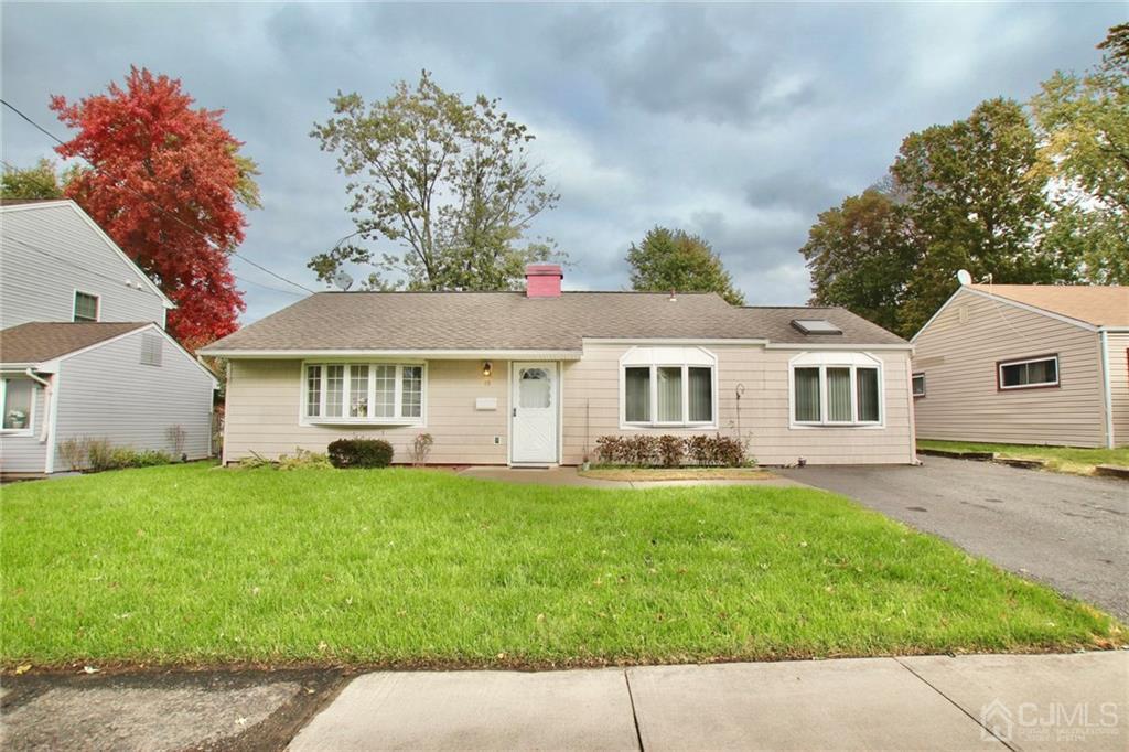 19 Kenmore Road Edison, NJ 08817 - Photo 2 of 13 a front view of a house with a garden and trees