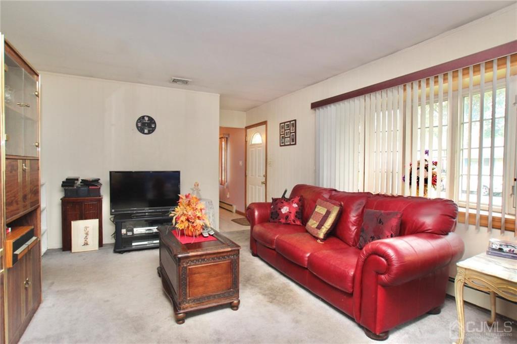 19 Kenmore Road Edison, NJ 08817 - Photo 4 of 13 a living room with furniture and a flat screen tv
