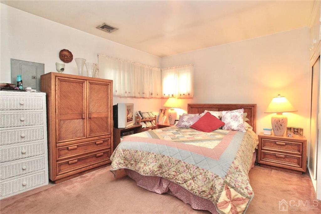 19 Kenmore Road Edison, NJ 08817 - Photo 5 of 13 a bedroom with a bed and a dresser