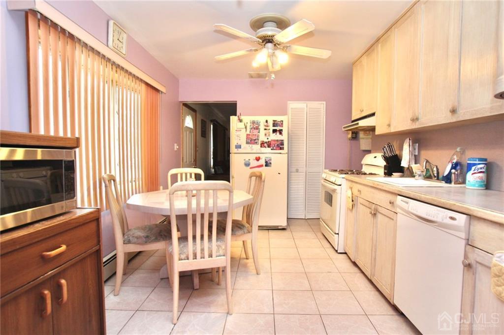 19 Kenmore Road Edison, NJ 08817 - Photo 8 of 13 a open kitchen with stainless steel appliances granite countertop a stove top oven a sink dishwasher and a dining table with the kitchen view