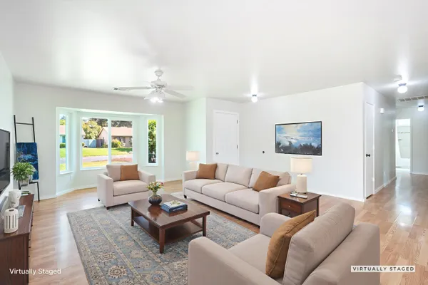 a living room with furniture and wooden floor