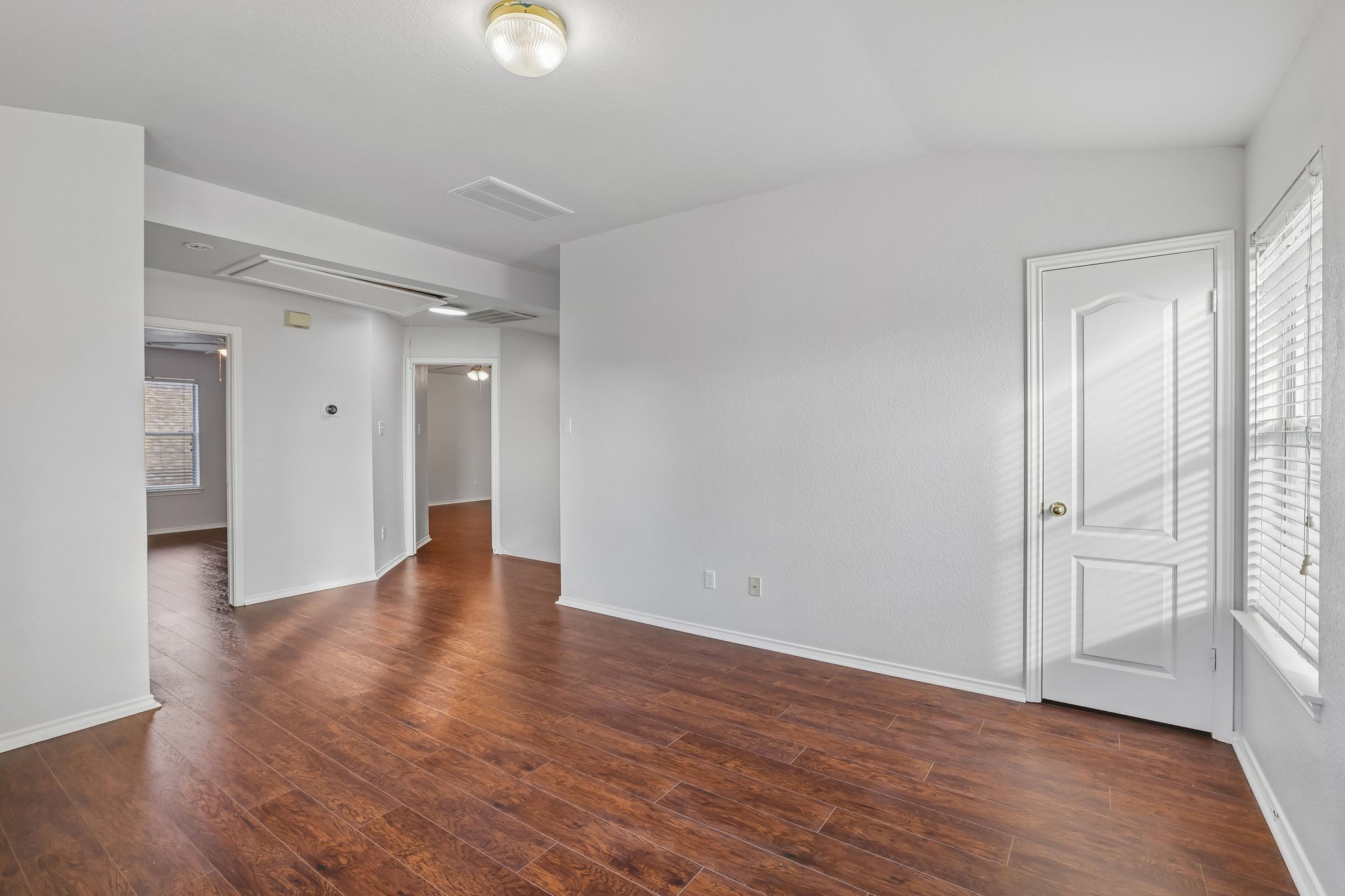 1721 Long Rifle Drive Austin, TX 78754 - Photo 21 of 38 Rich wood flooring extends through this airy living area, featuring sun-drenched windows.