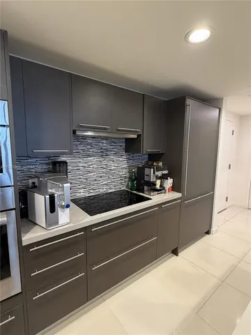 a kitchen with stainless steel appliances kitchen island granite countertop a sink and cabinets