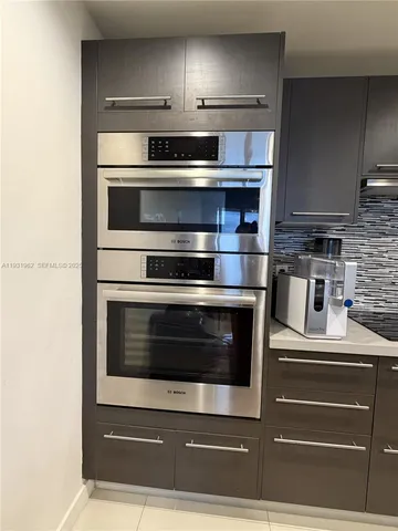 a kitchen with appliances and cabinets