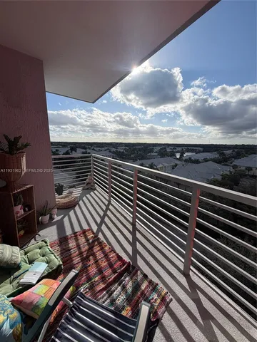 a view of a balcony with wooden floor
