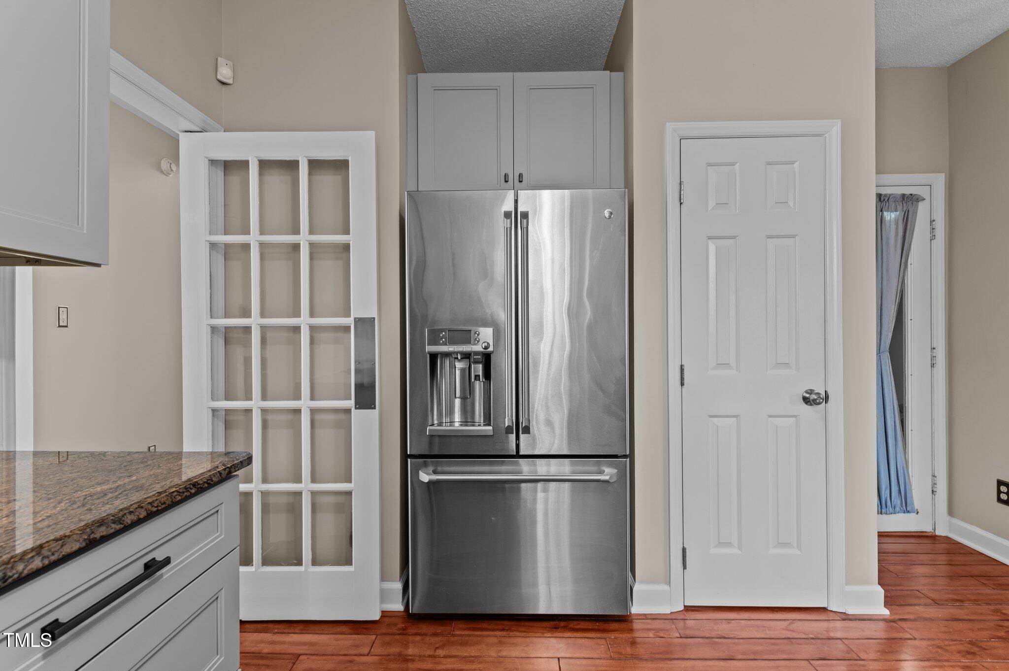 1217 Hillingdon Way Raleigh, NC 27614 - Photo 20 of 48 a kitchen with granite countertop a refrigerator and wooden floor