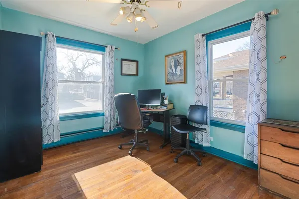 a view of a workspace with furniture and a window