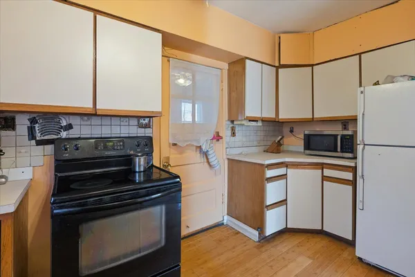 a kitchen with kitchen island a stove a sink and a counter top space
