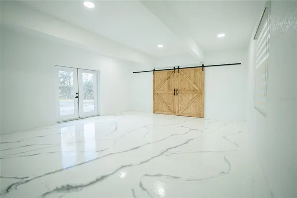 a bathroom with a double vanity sink a toilet and shower