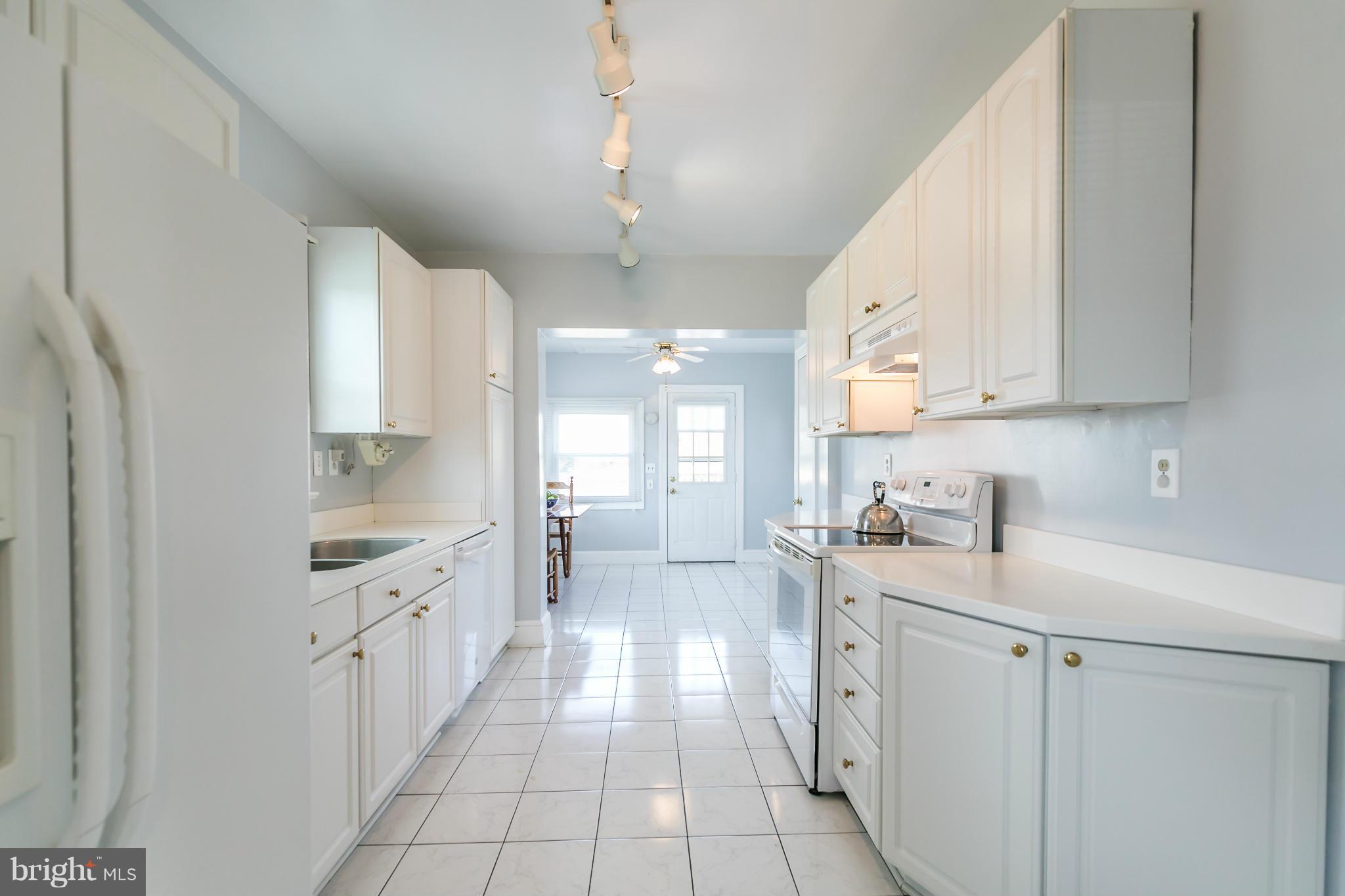20935 Potomac View Road Sterling, VA 20165 - Photo 11 of 30 a kitchen with white cabinets appliances and a sink