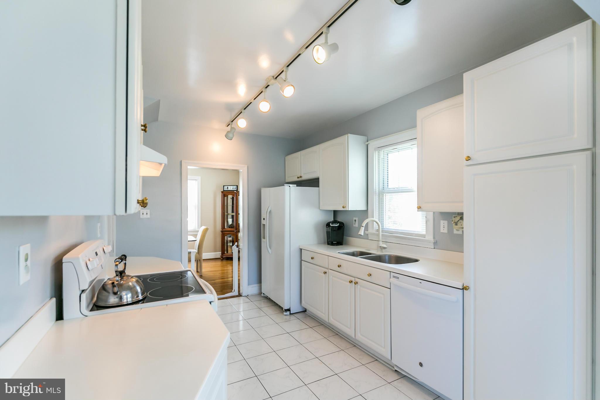 20935 Potomac View Road Sterling, VA 20165 - Photo 12 of 30 a kitchen with stainless steel appliances kitchen island a refrigerator sink and cabinets