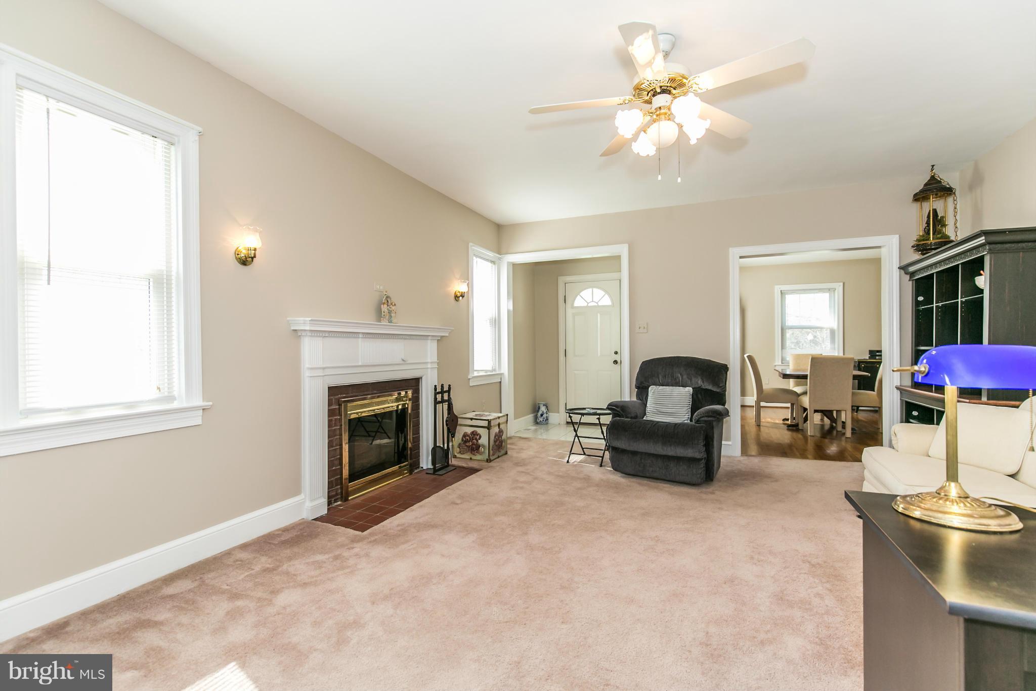20935 Potomac View Road Sterling, VA 20165 - Photo 6 of 30 a living room with furniture and a fireplace