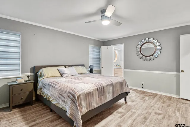 a bedroom with a bed and a chandelier