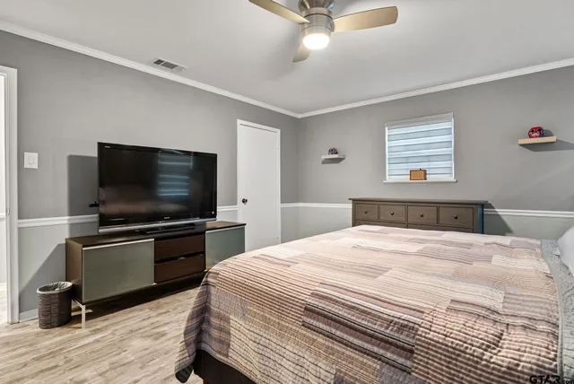 a bedroom with a bed and a flat screen tv