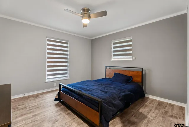 a bedroom with a bed and a chandelier