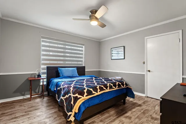 a bedroom with a bed and a chandelier