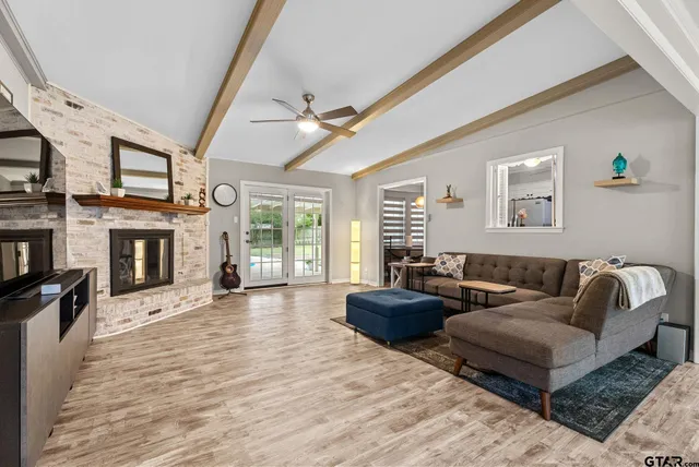 a living room with fireplace furniture and a flat screen tv
