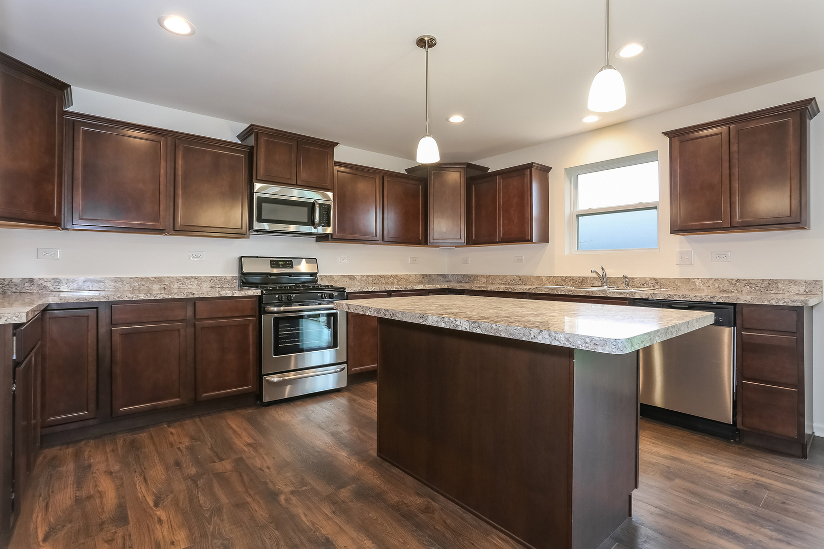 2026 Rownham Hill Road New Lenox, IL 60451 - Photo 4 of 15 a kitchen with stainless steel appliances granite countertop a stove a sink and a microwave