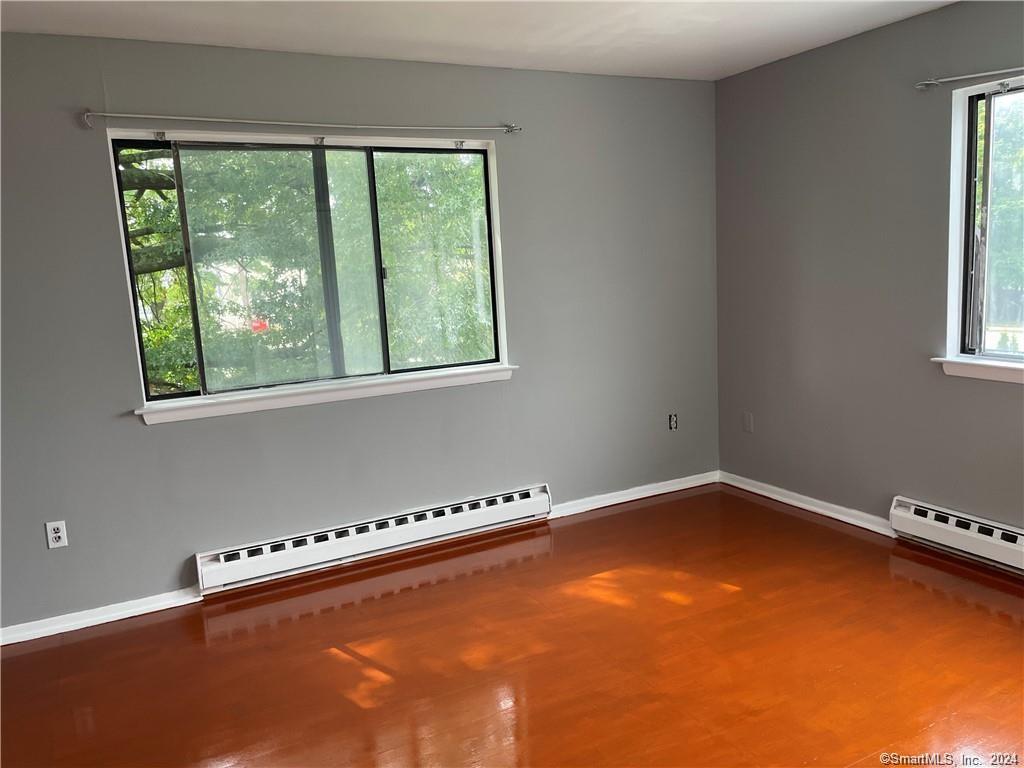 235 Cove Road, Unit 1 Stamford, CT 06902 - Photo 6 of 9 a view of an empty room with a window and staircase