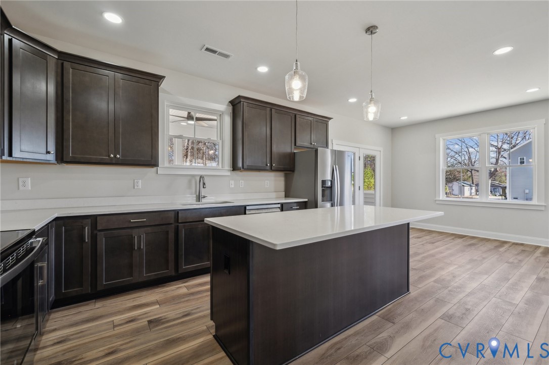 2910 Congress Road North Chesterfield, VA 23237 - Photo 10 of 20 a kitchen with stainless steel appliances granite countertop a sink stove and refrigerator