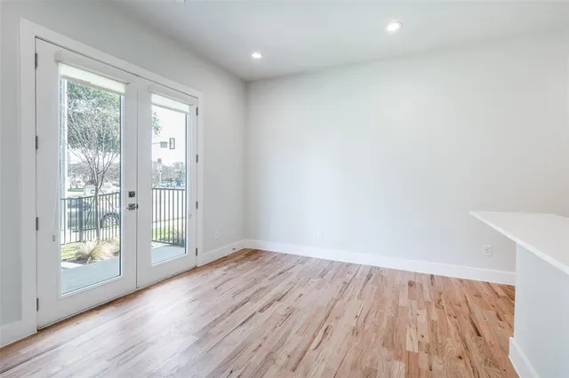 a kitchen with granite countertop a sink appliances wooden floor and cabinets