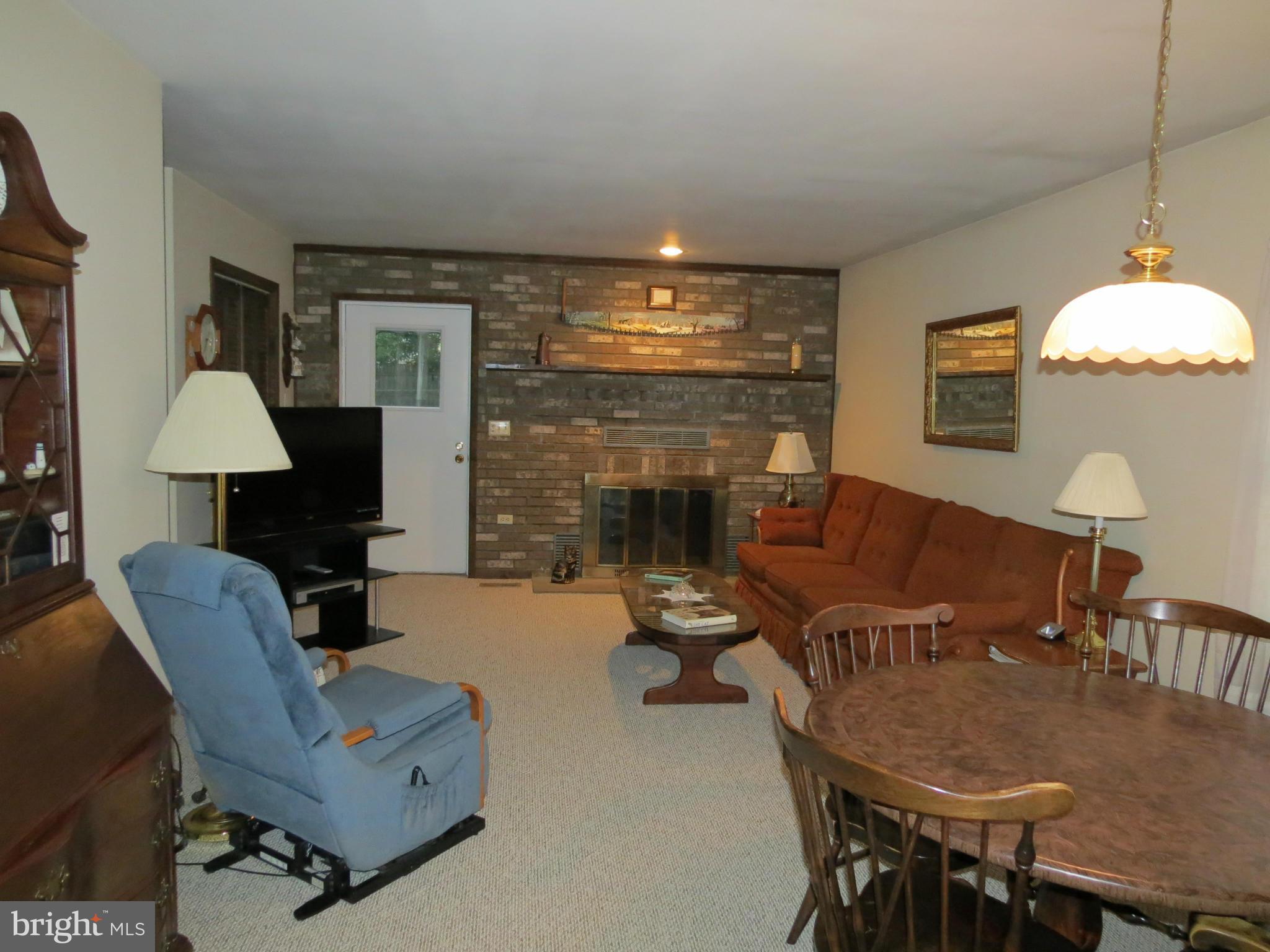 12129 Selfridge Road Silver Spring, MD 20906 - Photo 13 of 28 Family Room- Gorgeous brick fireplace door to deck