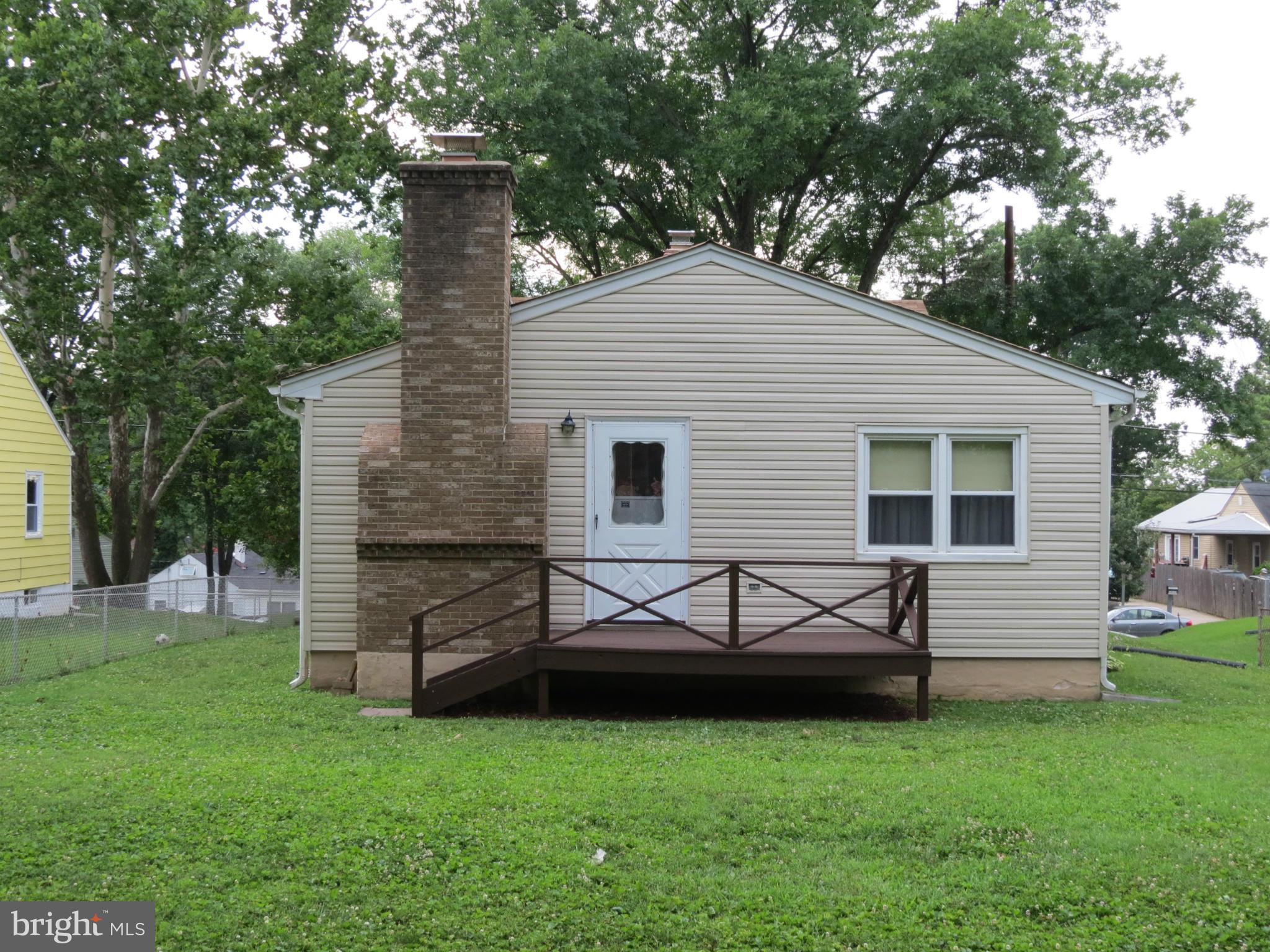 12129 Selfridge Road Silver Spring, MD 20906 - Photo 5 of 28 Rear view showing deck, masonry fireplace
