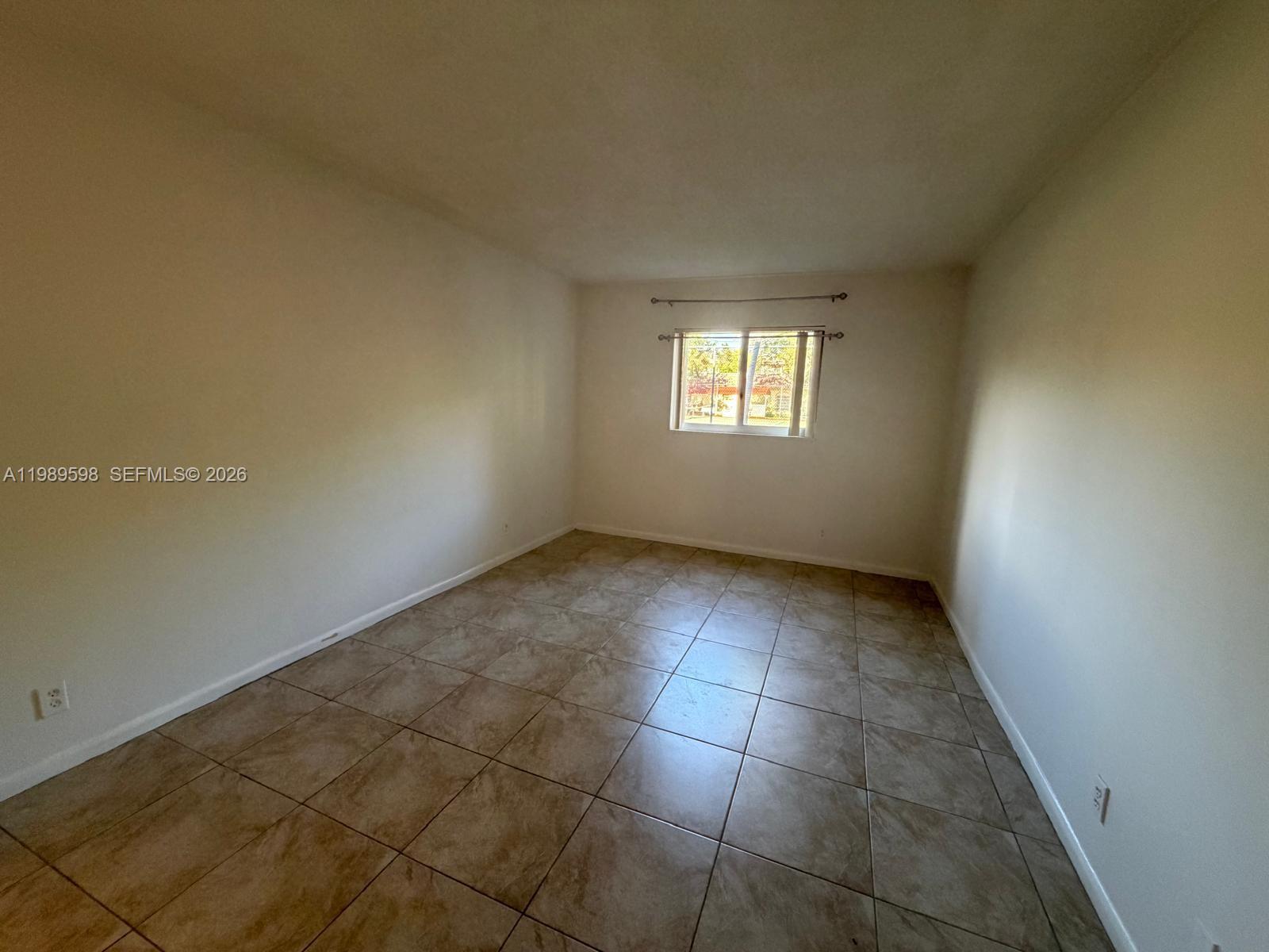 253 South Cypress Road, Unit 214 Pompano Beach, FL 33060 - Photo 8 of 25 an empty room with windows
