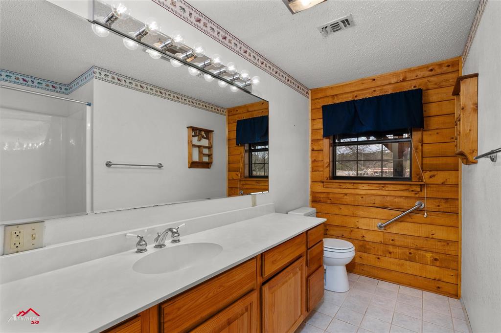 6951 Mira Myrtis Road Ida, LA 71044 - Photo 26 of 32 Full bath featuring a textured ceiling, visible vents, walk in shower, toilet, and vanity