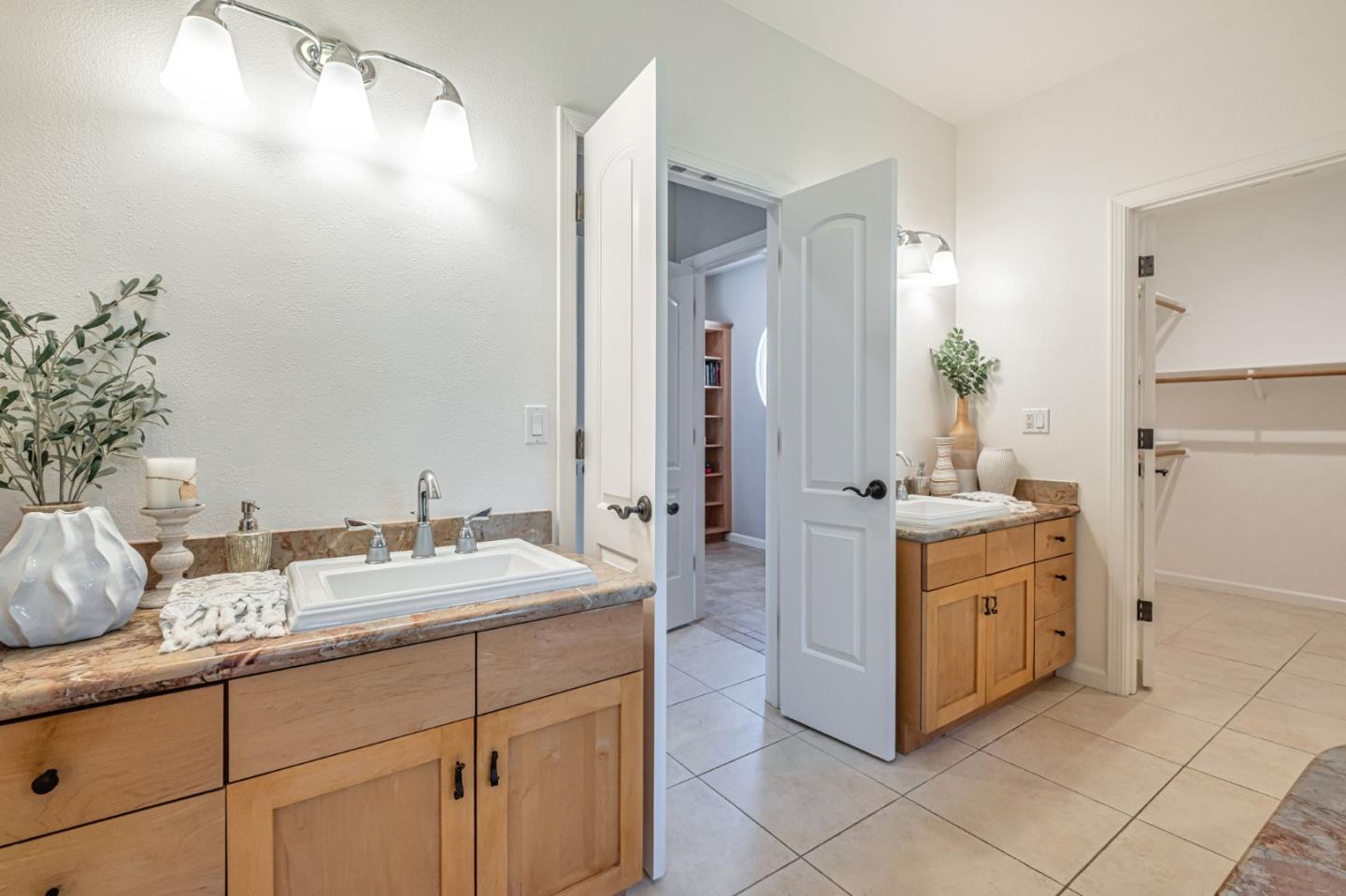 125 Zanzibar Drive Aptos, CA 95003 - Photo 40 of 52 a bathroom with a granite countertop sink and a mirror