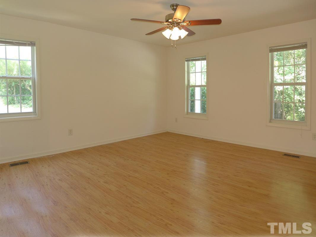 304 Davie Road Carrboro, NC 27510 - Photo 3 of 18 an empty room with windows and fan