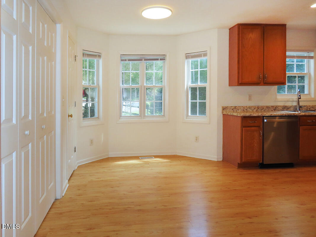 304 Davie Road Carrboro, NC 27510 - Photo 10 of 18 wooden floor in an empty room with a window