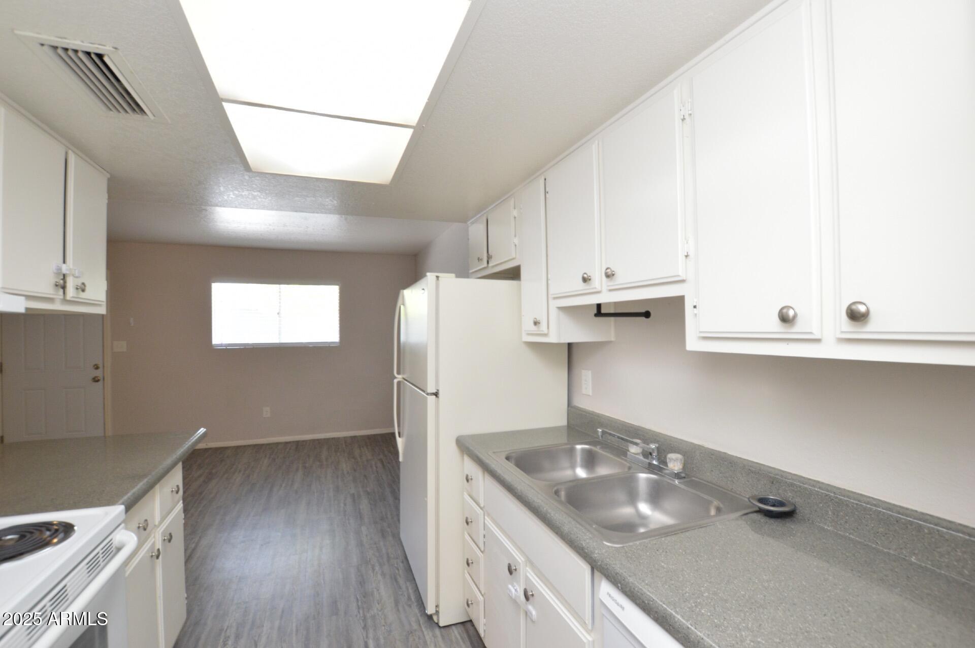 3004 East Waltann Lane, Unit 7 Phoenix, AZ 85032 - Photo 5 of 12 a kitchen with a sink cabinets and wooden floor