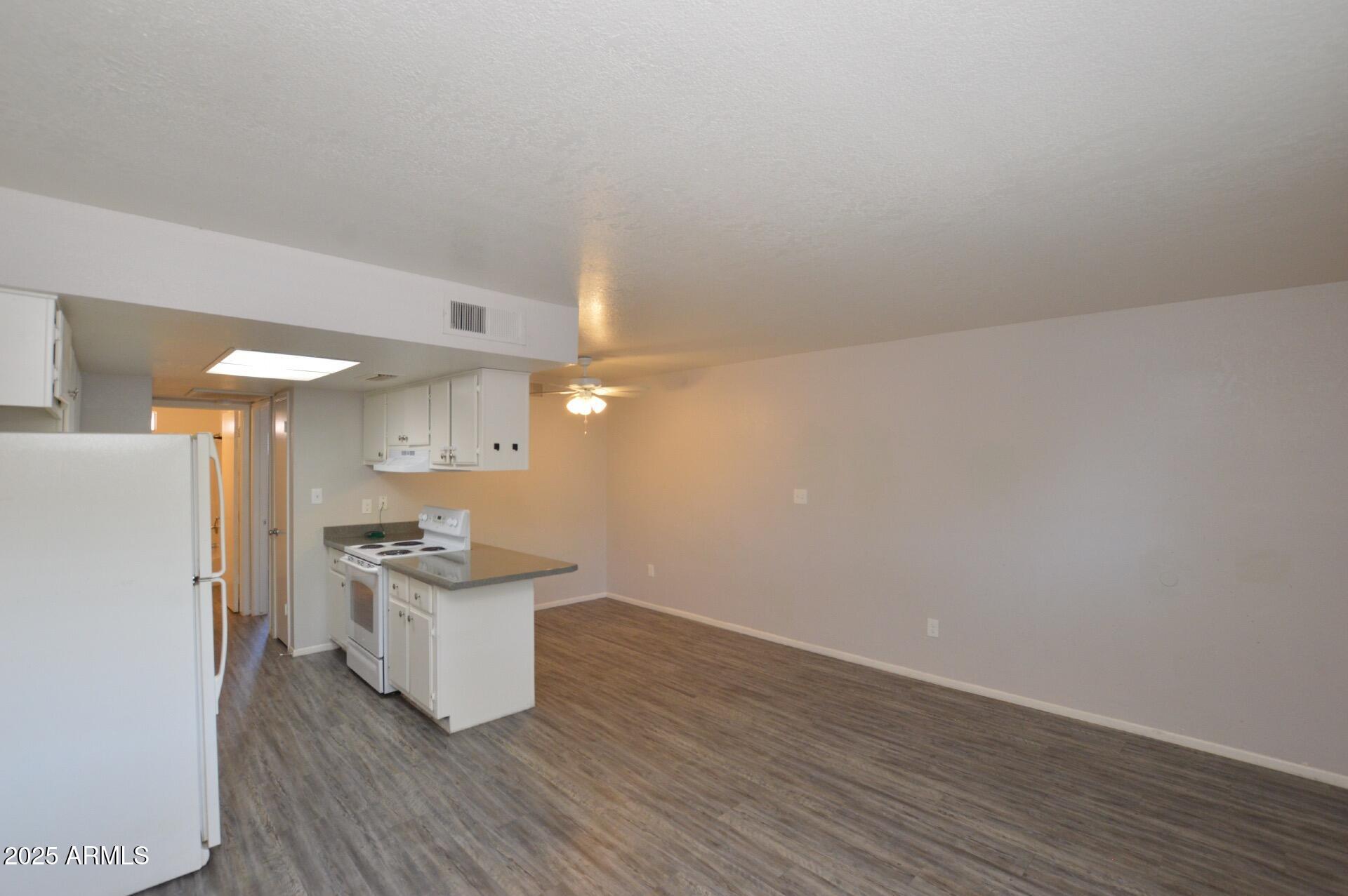 3004 East Waltann Lane, Unit 7 Phoenix, AZ 85032 - Photo 7 of 12 a view of a kitchen with a sink and a refrigerator